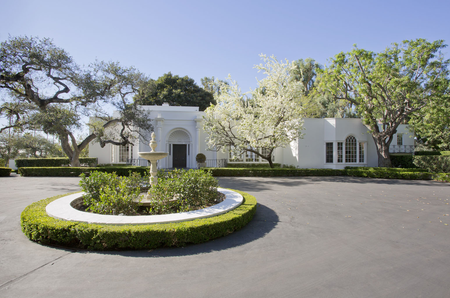 Ground renovation of Hillcrest Estate in Beverly Hills. Exterior restoration of historic home and pool house.