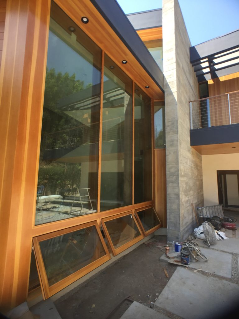 Exterior view of new front entryway with lower, louvered windows at the ground height