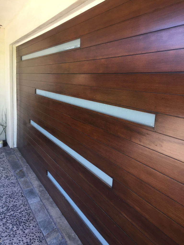 Custom garage door design. made of wood with opaque class. modern style garage desgn