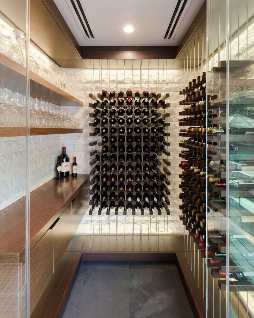 Custom designed wine storage room with Wenge Wood and suspended wine storage.
