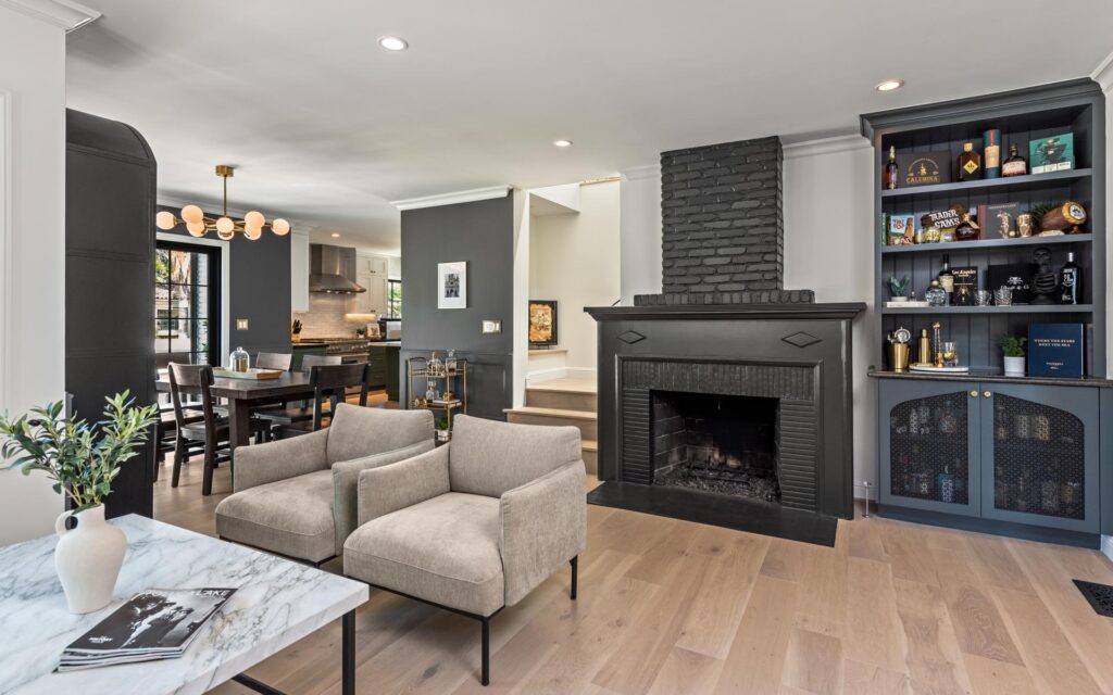 New stairwell wrapped around black painted fireplace to new second story addition