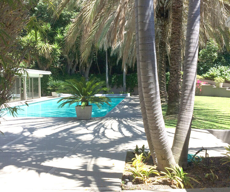 Before photo of pool house renovation in Bel Air on hillside sloped lot.
