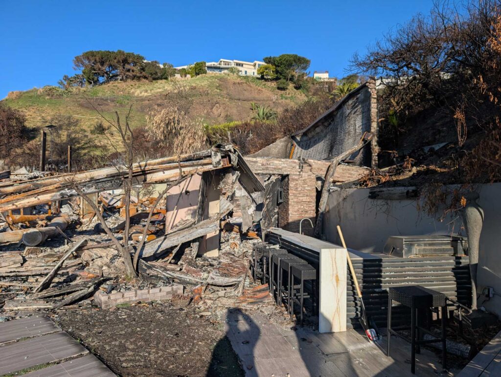 Hillside house fire debris in Pacific Palisades